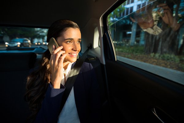 Business Executive Talking On Mobile Phone In Car